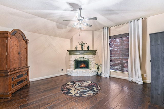 living room with ceiling fan, a fireplace, lofted ceiling, and dark hardwood / wood-style floors