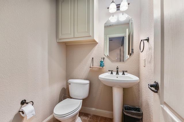 bathroom with tile patterned flooring, sink, and toilet