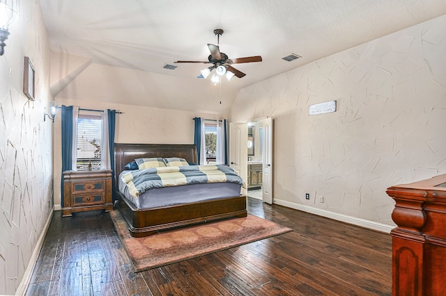 bedroom with vaulted ceiling, dark wood-type flooring, a textured ceiling, and ceiling fan