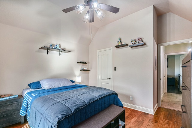 bedroom featuring ceiling fan, lofted ceiling, and dark hardwood / wood-style floors