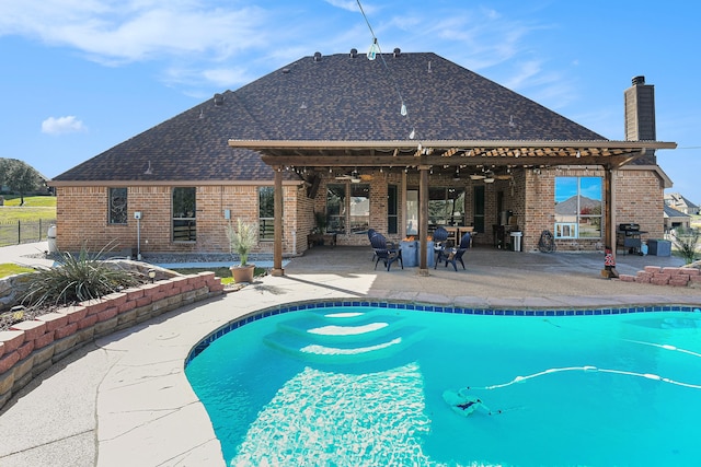 view of swimming pool featuring grilling area, a patio, and ceiling fan