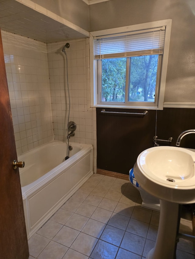 bathroom featuring tile patterned flooring and tiled shower / bath