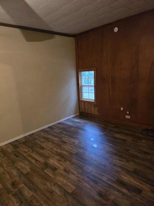 708 Walnut St, Atlanta, TX 75551 - unfurnished room featuring dark wood-type flooring, wooden walls, and baseboards