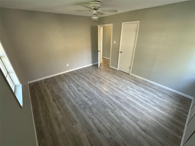 424 E Ragley St, Henderson, TX 75654 - empty room with ceiling fan, dark wood finished floors, and baseboards