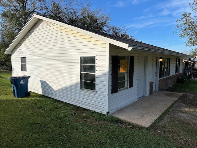 view of property exterior featuring a lawn