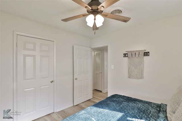 bedroom with light hardwood / wood-style flooring and ceiling fan