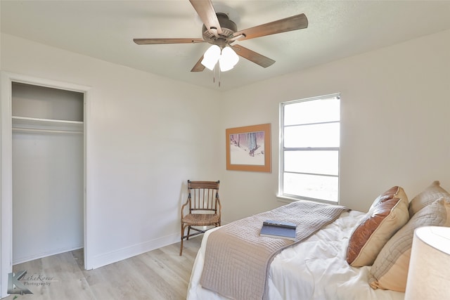 bedroom featuring a closet, light hardwood / wood-style floors, and ceiling fan