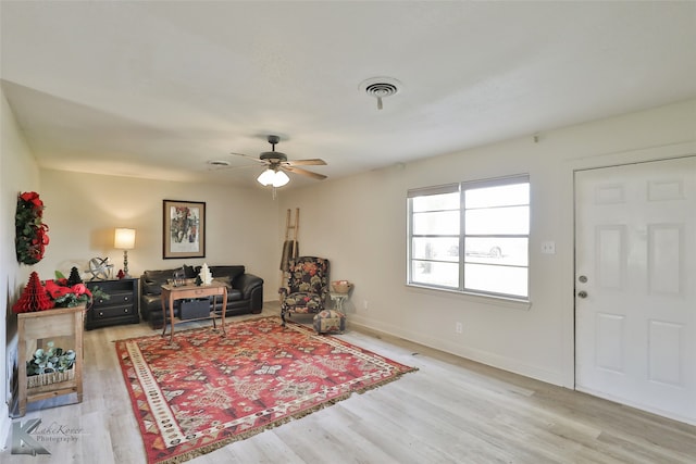 living room with ceiling fan and light hardwood / wood-style floors