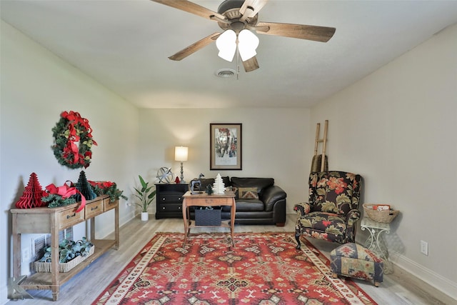 living room with hardwood / wood-style flooring and ceiling fan