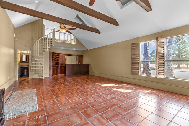 unfurnished living room featuring ceiling fan, tile patterned floors, and beamed ceiling