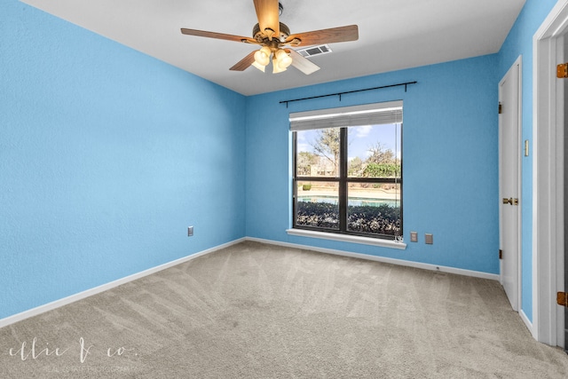 spare room featuring carpet and ceiling fan