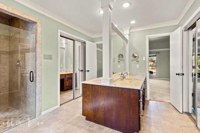 bathroom featuring walk in shower, ornamental molding, decorative columns, and vanity