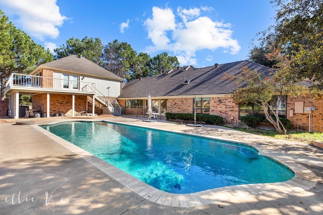 view of pool with a patio area and central air condition unit