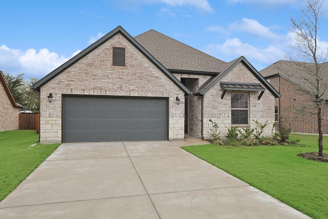 view of front of property with a garage and a front lawn