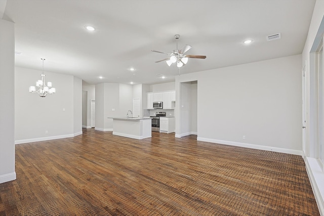 unfurnished living room with sink and ceiling fan with notable chandelier