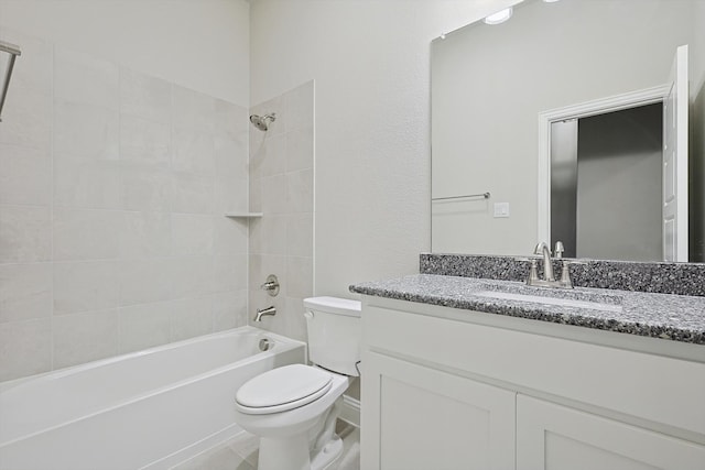 full bathroom featuring tiled shower / bath, vanity, and toilet