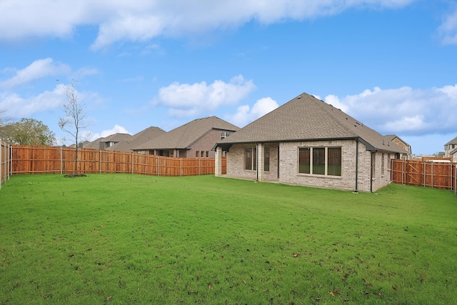 back of house featuring a yard