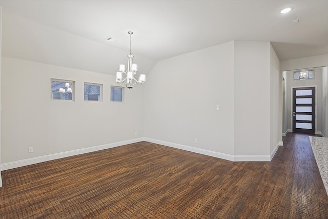 unfurnished room with dark hardwood / wood-style flooring, lofted ceiling, and a chandelier