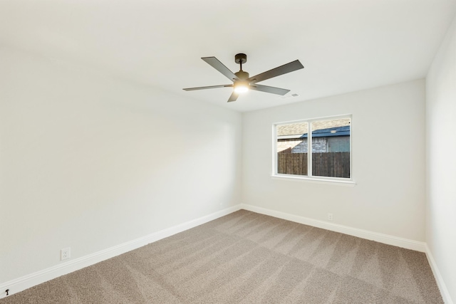 spare room featuring carpet and ceiling fan