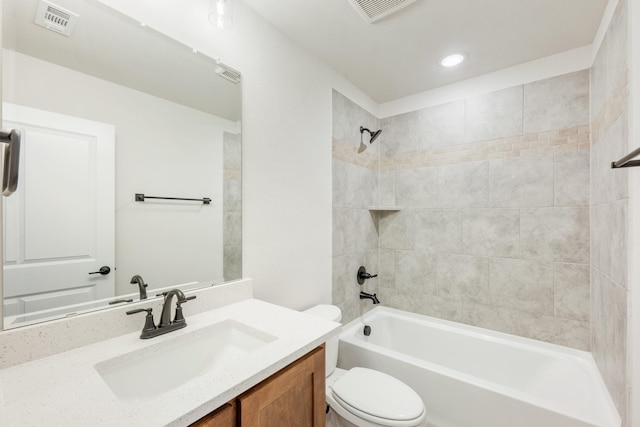 full bathroom featuring vanity, toilet, and tiled shower / bath combo