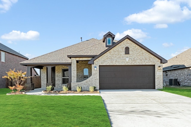 view of front facade featuring covered porch, a garage, a front lawn, and central air condition unit