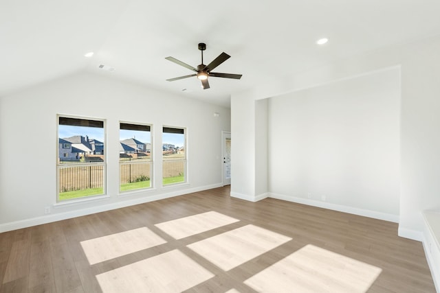 unfurnished room featuring ceiling fan, light wood-type flooring, and lofted ceiling