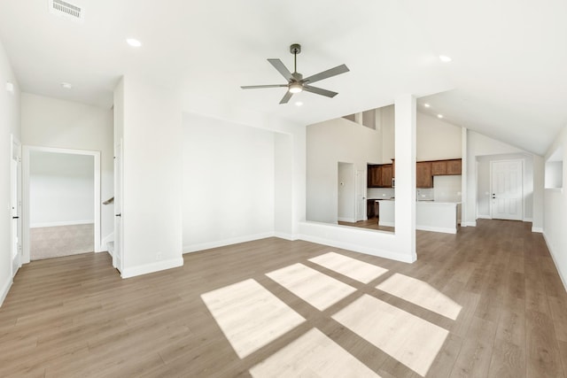 unfurnished living room featuring ceiling fan, high vaulted ceiling, and light hardwood / wood-style flooring