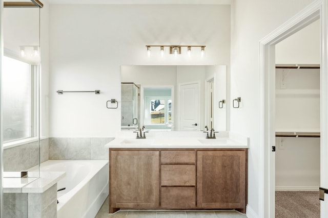 bathroom with tile patterned floors, vanity, and independent shower and bath