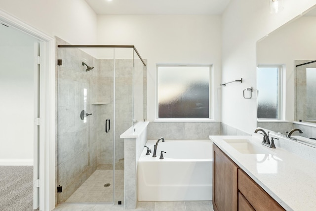 bathroom featuring tile patterned floors, vanity, and plus walk in shower