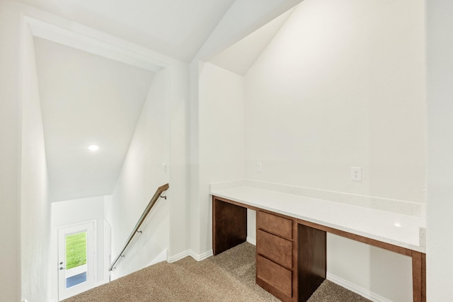 unfurnished office with light colored carpet and lofted ceiling