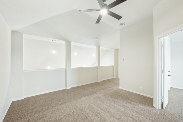 carpeted spare room with high vaulted ceiling and ceiling fan