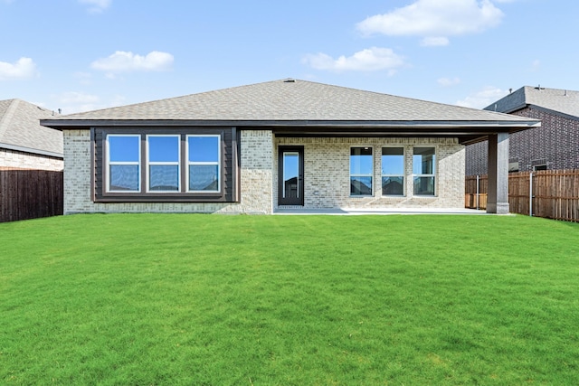 back of house featuring a lawn