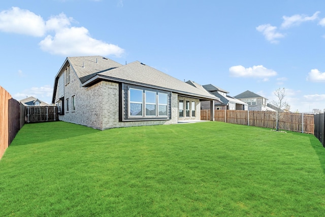 back of house featuring a yard