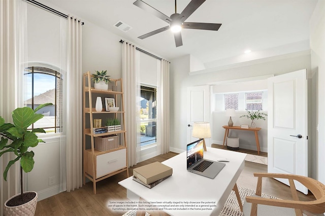 interior space with ceiling fan, plenty of natural light, and dark wood-type flooring