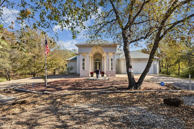 mediterranean / spanish home with a garage