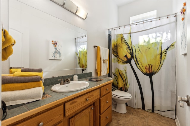 bathroom featuring tile patterned flooring, vanity, and toilet