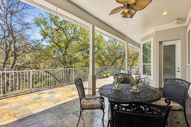 sunroom / solarium with ceiling fan, wooden ceiling, and a wealth of natural light