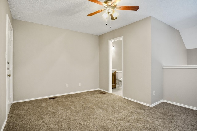 interior space featuring carpet floors, baseboards, visible vents, and a textured ceiling