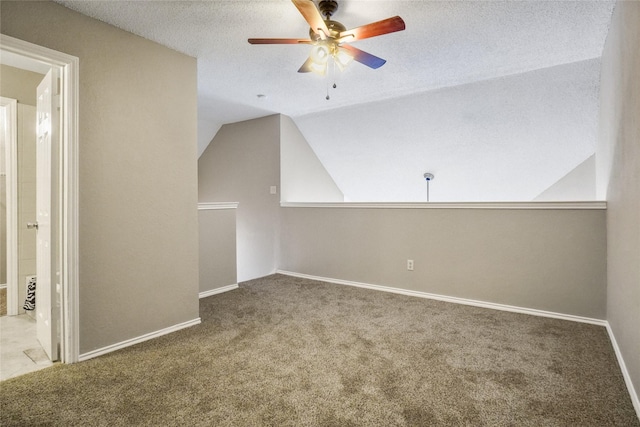 bonus room with a textured ceiling, carpet flooring, a ceiling fan, and lofted ceiling