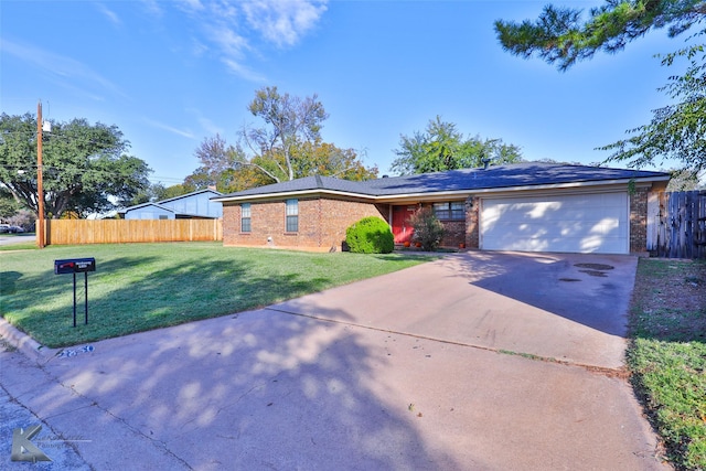 ranch-style home featuring a garage and a front yard