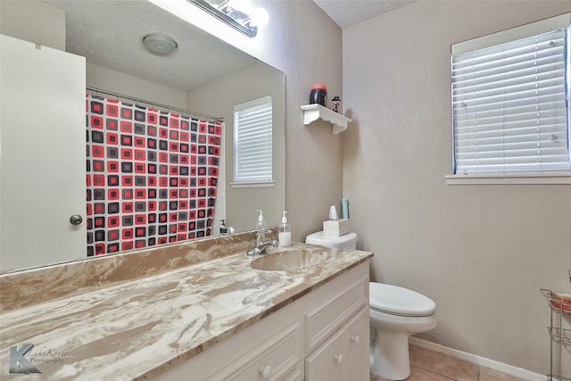 bathroom with vanity, tile patterned floors, a textured ceiling, and toilet