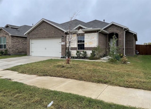 ranch-style house featuring a front yard and a garage