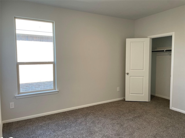 unfurnished bedroom featuring a closet and carpet floors