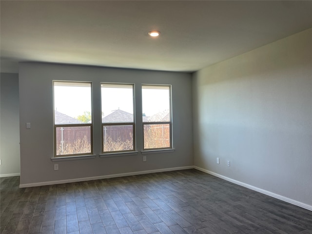 spare room with dark hardwood / wood-style flooring