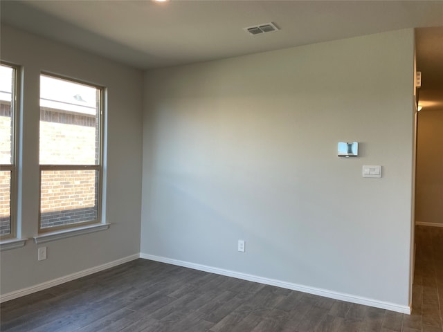 unfurnished room with dark hardwood / wood-style floors