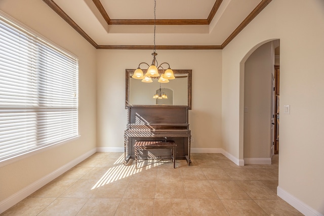 misc room featuring plenty of natural light, ornamental molding, and a chandelier