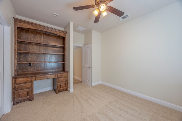 unfurnished office featuring ceiling fan and light colored carpet