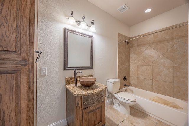 full bathroom with tile patterned flooring, vanity, toilet, and tiled shower / bath