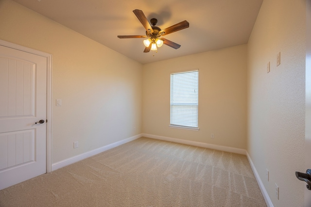 spare room with light carpet and ceiling fan