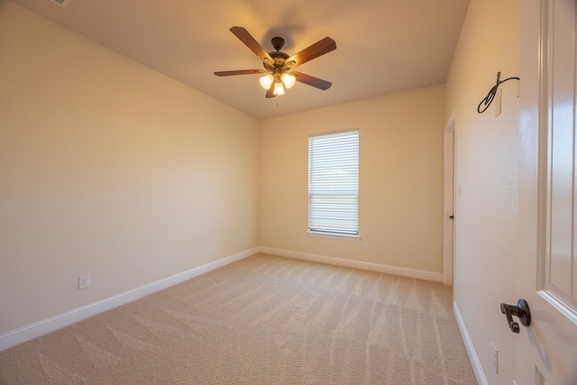 spare room with light carpet and ceiling fan